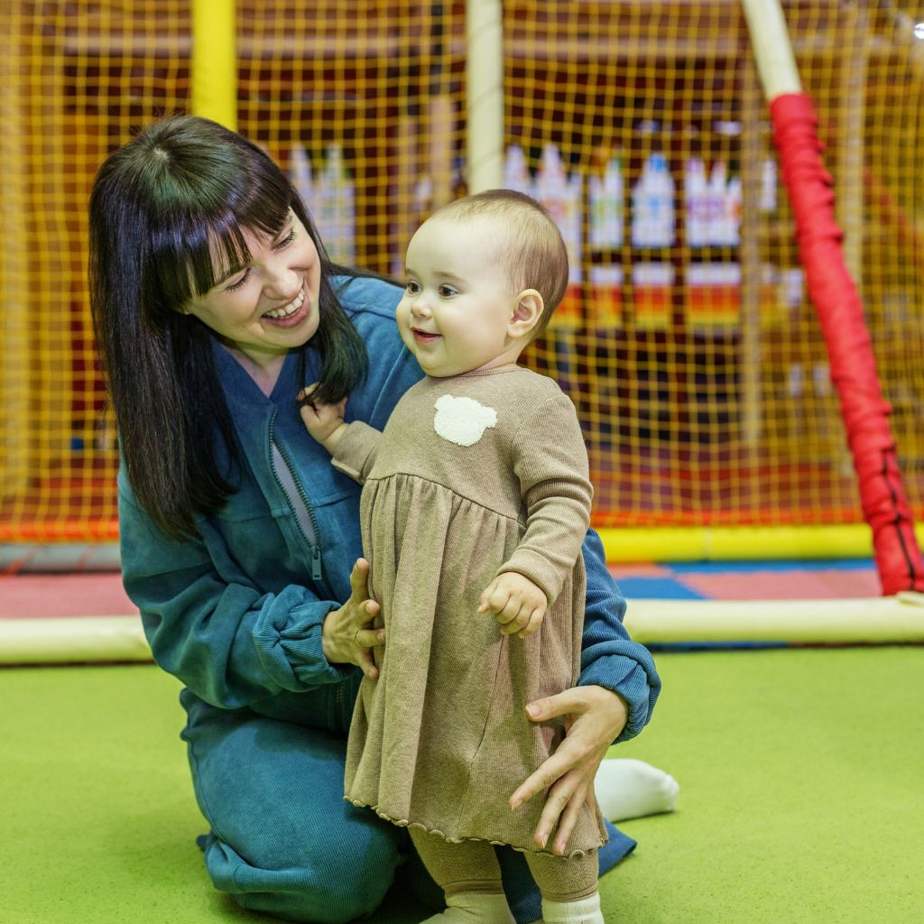Photo of mother with child in play place 